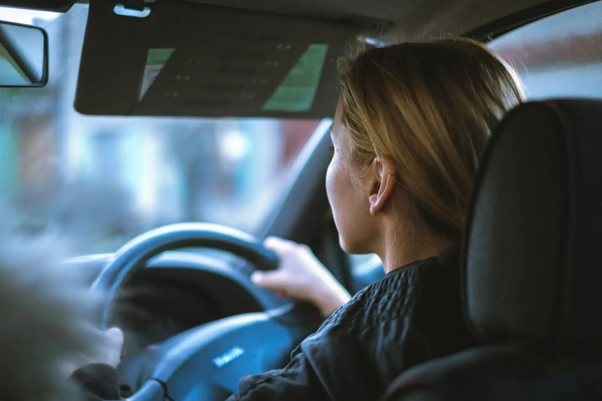 side view of woman in drivers seat