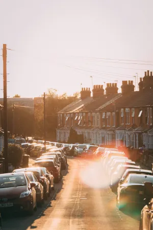 street of parked cars with lens flare